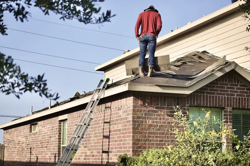 Professional roofer working on a residential roof in Hondo
